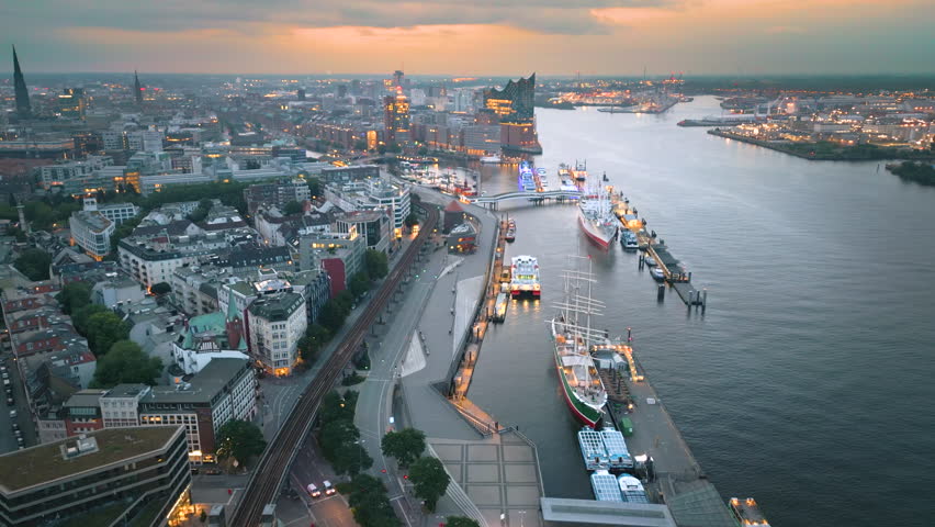 Aerial view over the Hamburg at night, sunset. drone flying over Alster lake. city skyline. Germany. In front Elbphilharmonie (concert hall) , German harbor Hafen city , Elbe River