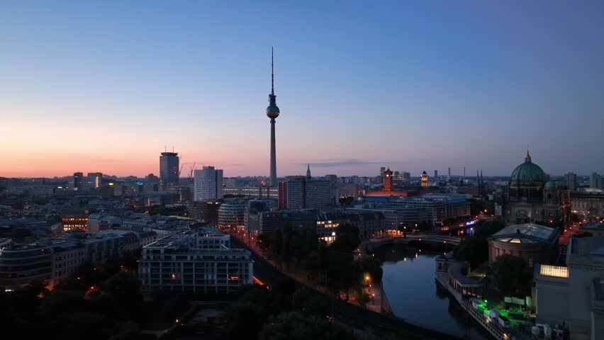 Aerial view of famous places architectural landmarks TV Tower and Berlin Cathedral, Alexanderplatz at night. Drone flight above City of Berlin, Germany