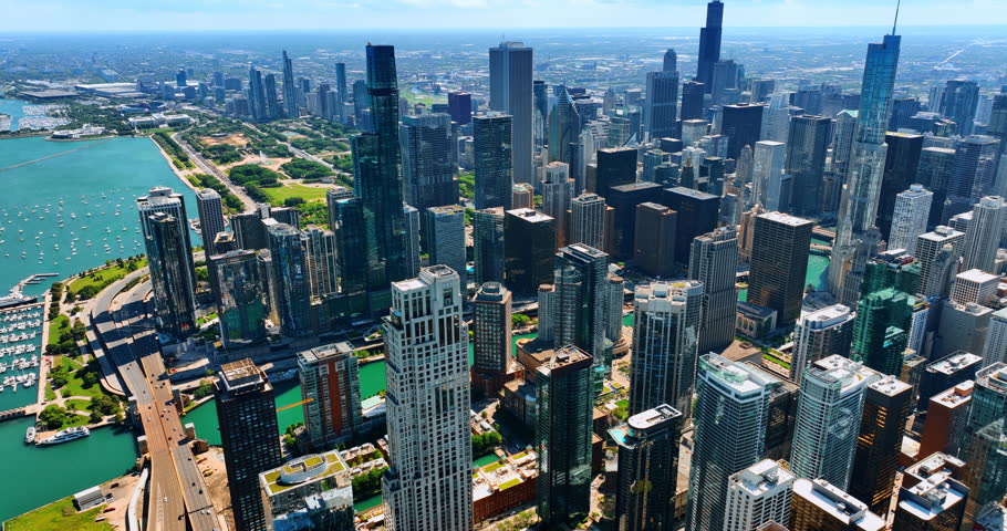 Spectacular scenery of modern Chicago architecture at the lakefront of Lake Michigan. Multiple yachts are at the shore of the city. Top view.