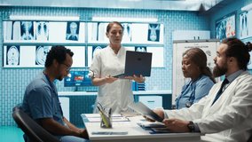 Team of doctors review electrocardiogram test results at a private facility, analyzing human organs on a radiography for disease prevention. Consulting hospital records and cardiology scan. Camera B. - Powered by Shutterstock - Get 15% off with code: PIKWIZARD15