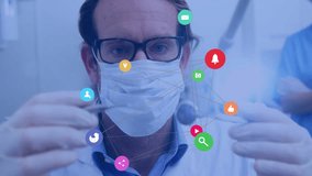 Medical professional holding dental tools with social media icons animation over image. Dentist, healthcare, technology, dental care, digital - Powered by Shutterstock - Get 15% off with code: PIKWIZARD15