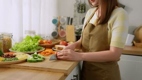 Close up of woman cooking healthy foods in kitchen in morning at home. Attractive female housewife feeling happy and relax, enjoy preparing ingredients and making green salad for breakfast in house. - Powered by Shutterstock - Get 15% off with code: PIKWIZARD15