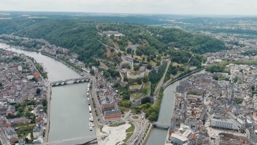 Dolly zoom. Namur, Belgium. Citadelle de Namur - 10th-century fortress with a park, rebuilt several times. Panorama of the central part of the city. River Meuse. Summer day, Aerial View