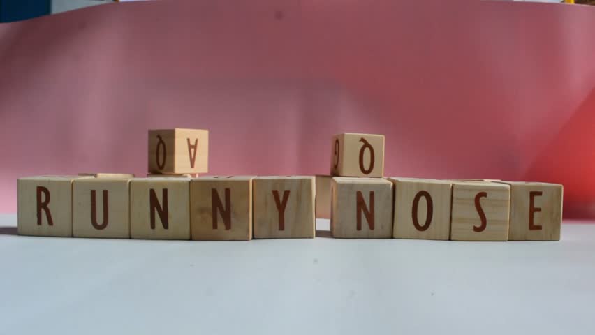 RUNNY NOSE word written on wood block. Content text on wooden table for your desing, concept.
