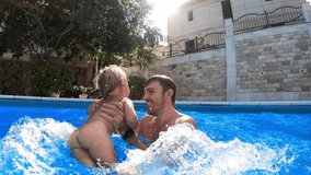 Dad spins a little girl in the pool holding her hands - Powered by Shutterstock - Get 15% off with code: PIKWIZARD15