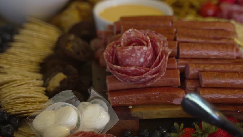 Charcuterie board decorative layout - salami shaped into a rose