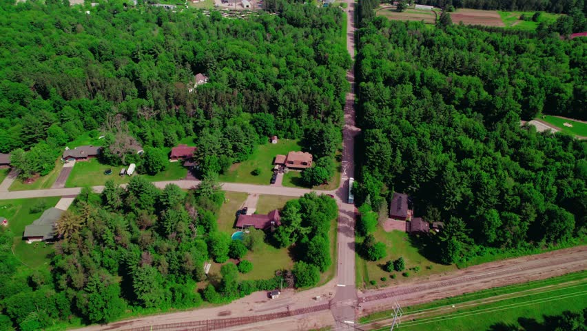 Aerial view of a semi-truck with hopper grain trailer navigating rural roads in Wisconsin, highlighting countryside logistics and farming logistics.