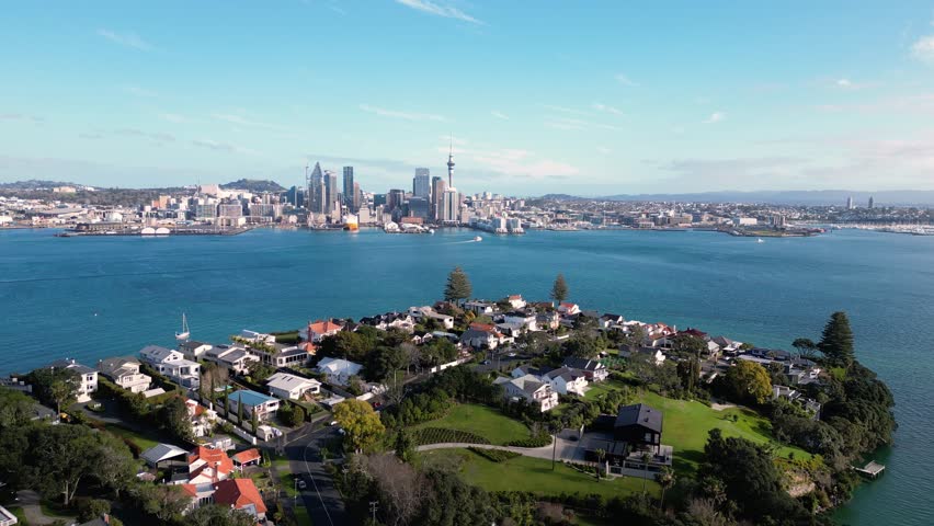 Auckland, New Zealand: Aerial drone footage of the luxury residential district of Stanley Point with Auckland downtown district skyline in the background. 