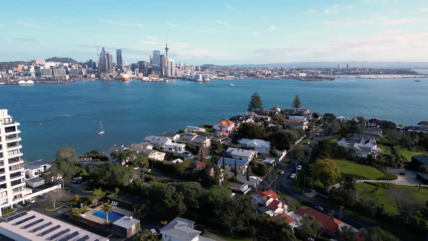 Auckland, New Zealand: Aerial drone footage of the luxury residential district of Stanley Point with Auckland downtown district skyline in the background. 