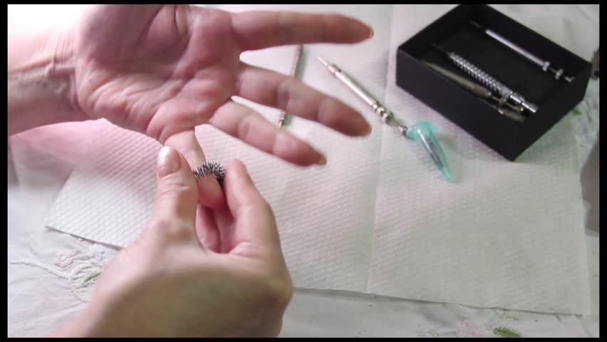 Alternative medicine, SuJok Therapy: demonstration of a massage ring in use.