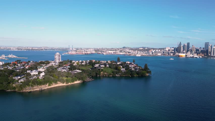 Auckland, New Zealand: Aerial drone footage of the luxury residential district of Stanley Point with Auckland downtown district skyline in the background. 