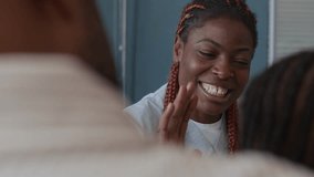 Close up view of smiling African American female family doctor removing stethoscope and giving high-five to unrecognisable child after medical examination in kids clinic - Powered by Shutterstock - Get 15% off with code: PIKWIZARD15