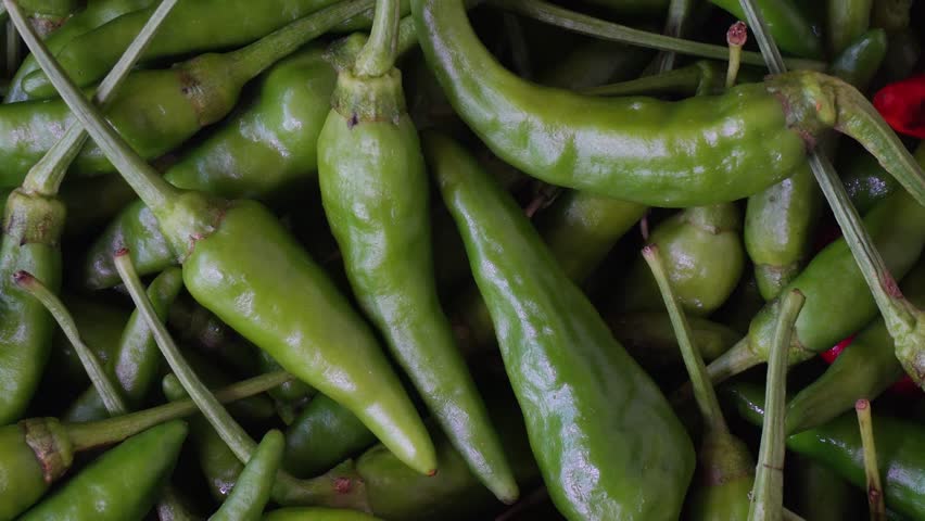 Green chili close-up. Rotating cayenne pepper
