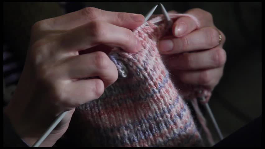 Girl is knitting, hands close up
