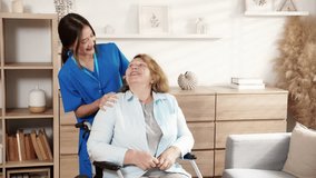 Caregiver young woman care elderly sitting on wheelchair and support in living room at home, senior therapy with nurse, doctor help with patient and support with service, insurance and medical. - Powered by Shutterstock - Get 15% off with code: PIKWIZARD15