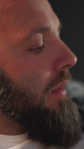 Bearded man takes prescribed capsule drinking with water from white cup. Male with cardiac disease takes dietary supplement to improve health condition closeup