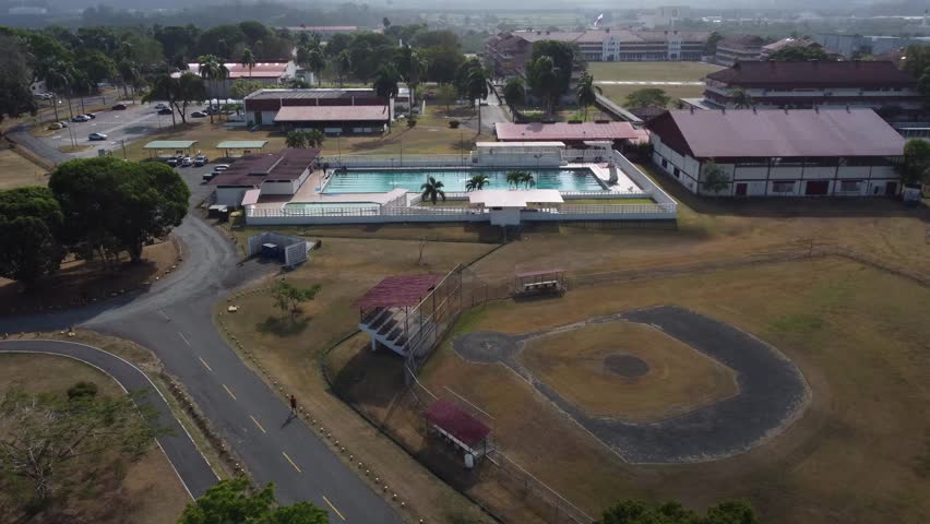 drone view of the university swimming pool in the middle of campus
