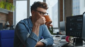 Office worker drinking coffee in corporate agency closeup. Focused professional in eyeglasses taking break enjoying tea. Serene businessman looking monitor holding mug with hot beverage at workday - Powered by Shutterstock - Get 15% off with code: PIKWIZARD15