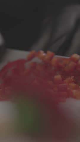 Selective shot of cut peppers with some cut onions.