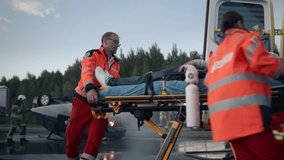Car Crash Traffic Accident: Team of Paramedics and Firefighters Rescue Injured Person in Rollover Vehicle. Emergency Medical Professionals Provide First Aid as Firemen Extinguish Fire. Slow Motion - Powered by Shutterstock - Get 15% off with code: PIKWIZARD15