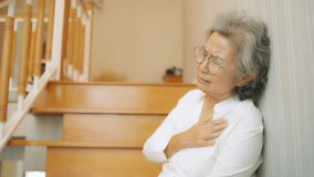 Senior people care, Emergency medical healthcare and health insurance. Asian elderly woman fell down the stairs suffering from heart attack feeling pain on chest area and difficulty breathing. - Powered by Shutterstock - Get 15% off with code: PIKWIZARD15
