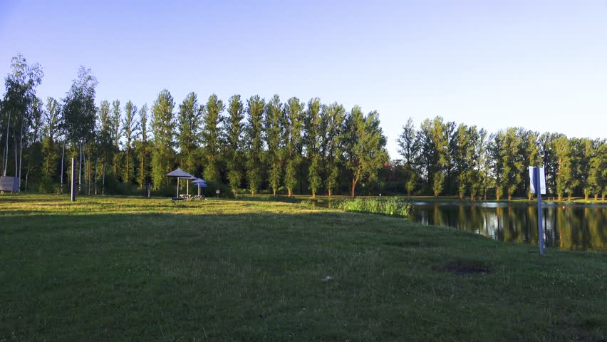Summer morning on the reservoir in the city 