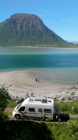 Explore the breathtaking beauty of Lofoten, Norway, traveling in an RV or camper van along serene beaches framed by stunning mountains perfect for travel enthusiasts and adventurous spirits