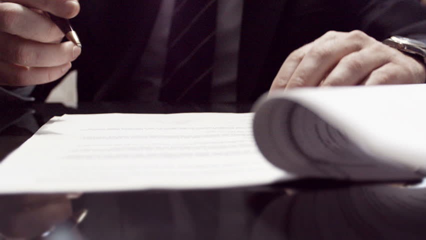 Businessman sitting at shiny office desk signing a contract with noble pen Royalty-Free Stock Footage #3582944