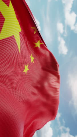 Wavy flag of China blowing in the wind in slow motion. Waving colorful Chinese flag team symbol abstract vertical background. Blue sky with clouds. World countries flying flags concept