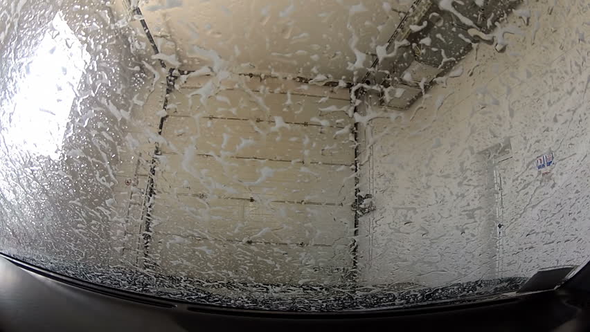 Automatic car wash. View from the car. A full wash cycle. Timelapse
