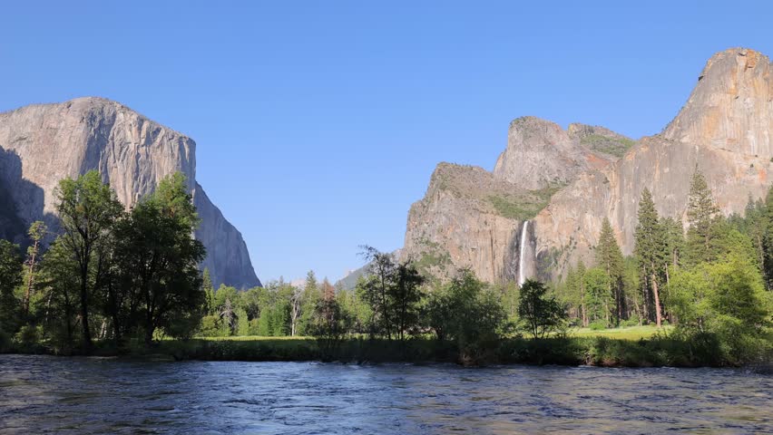 The Merced River as it runs through Yosemite National Park in California. El Capitan and Bridalveil Fall in the background. This video Loops seamlessly.