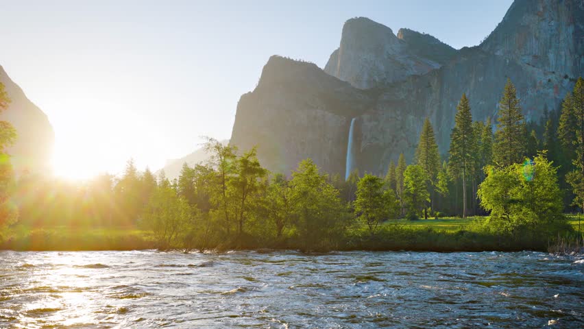 Merced River as it runs through Yosemite National Park in California. Bridalveil Fall can be seen in the background.