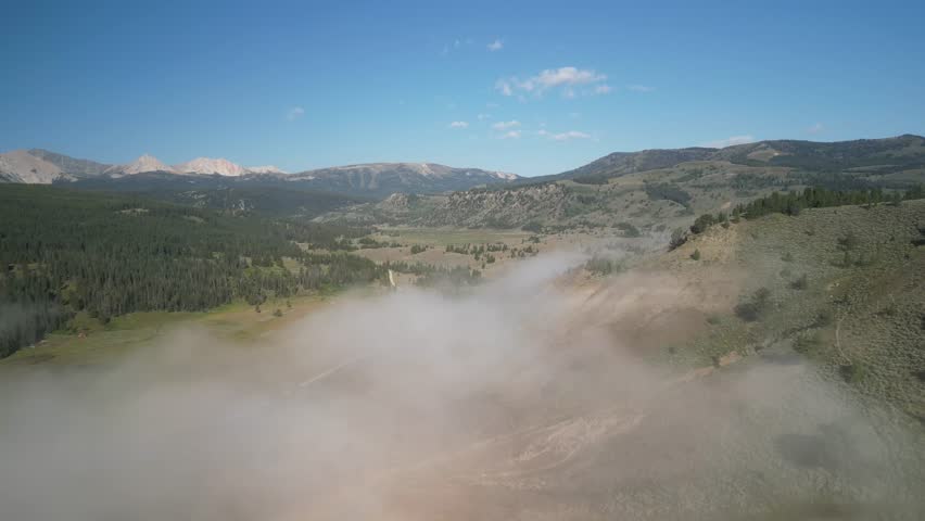 Aerial of Madison Range in Montana with low clouds on early summer morning