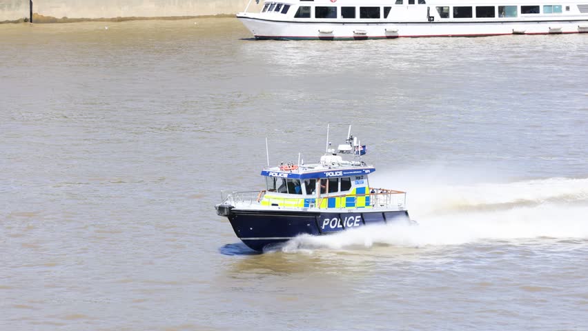 Police boat speeding on the Thames River