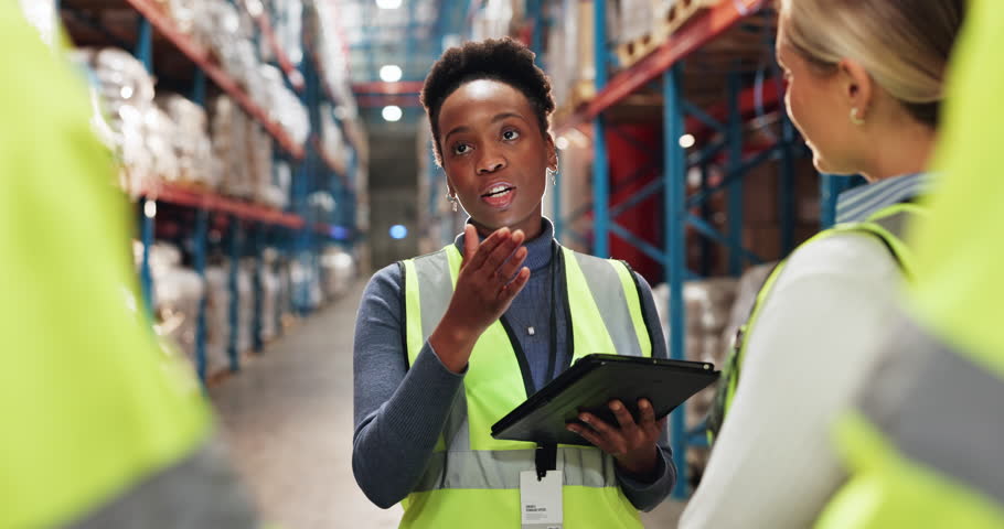 Manager, tablet and meeting in warehouse for inspection, compliance and safety training with people. Teamwork, logistics and tour for supply chain industry, project briefing and inventory management