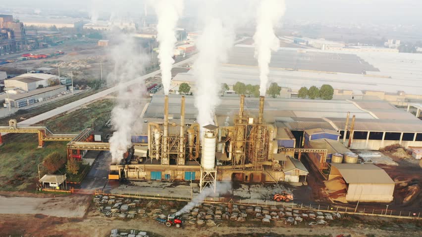 white smoke coming out of factory chimneys environmental pollution, industrial gas and waste, poisonous smoke and gas. industrialization and the difficulty of living in a big city. dangerous lives