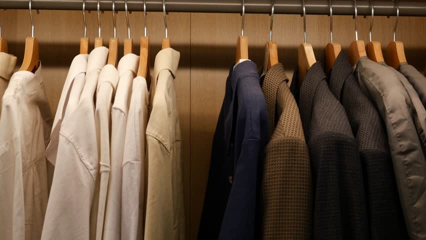 Stylish Wardrobe Showcase An Exquisite Collection of Elegant Shirts and Suits Hanging on Hangers