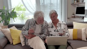Relaxed senior couple on home sofa using laptop enjoying technology, elderly 70 years old caucasian people sitting in living room browsing, shopping on line, following social media together - Powered by Shutterstock - Get 15% off with code: PIKWIZARD15