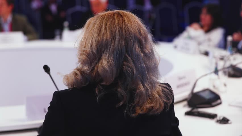 Group of women in business suits at round table, board meeting, roundtable talking and discussing at conference, female politicians and entrepreneurs, businesswomen dialog on forum, panel discussion