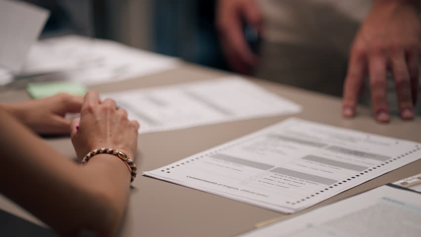 close up In the selection committee of the election company a guy registers to vote a young girl tells how to vote the rights of society