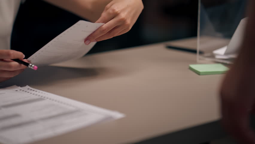 close up In the selection committee of the election company a guy registers to vote a young girl tells how to vote the rights of society