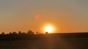 Bright sun rises over the horizon of a field, creating a lens flare effect - Powered by Shutterstock - Get 15% off with code: PIKWIZARD15