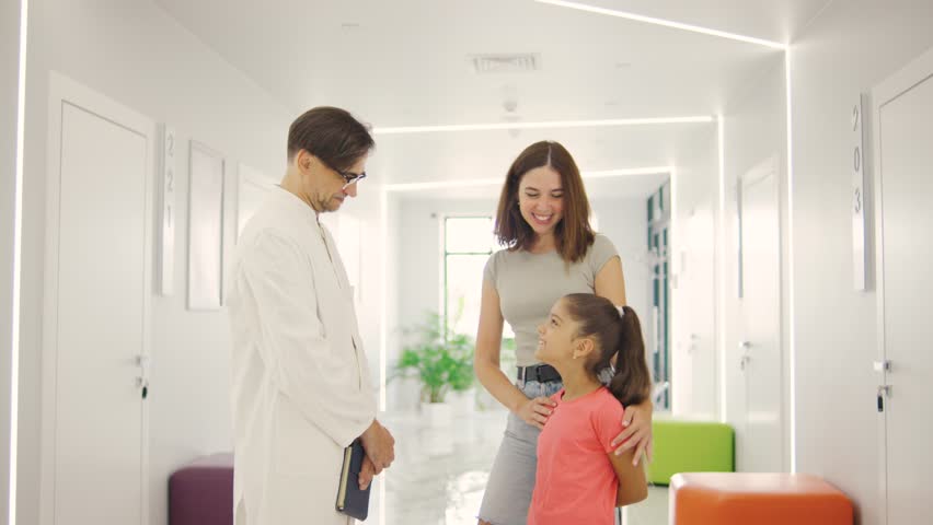 Consultation between a doctor, child, and parent in a welcoming modern medical office that prioritizes family care and wellbeing - Powered by Shutterstock - Get 15% off with code: PIKWIZARD15