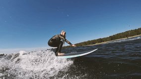 smiling beautiful surfer girl with blond long hair rides wave on a longboard in slow motion - Powered by Shutterstock - Get 15% off with code: PIKWIZARD15