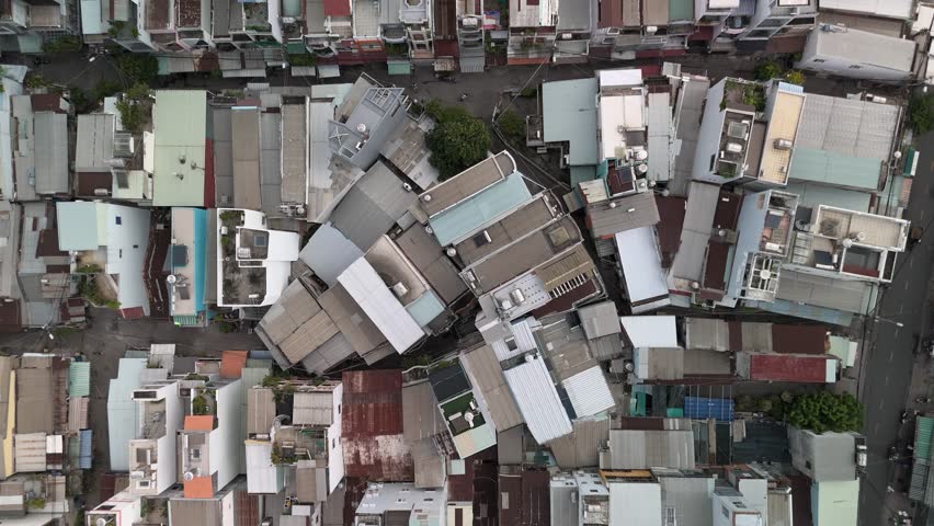 Ho Chi Min City, Vietnam District eight from top down aerial view featuring rooftops, dense urban housing, streets and alleyways. Camera rotates CCW
