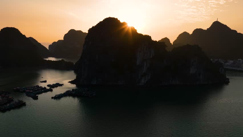 Aerial view floating fishing village and rock island, Halong Bay, Vietnam, Southeast Asia. UNESCO World Heritage Site. Junk boat cruise to Ha Long Bay. Popular landmark, famous destination of Vietnam
