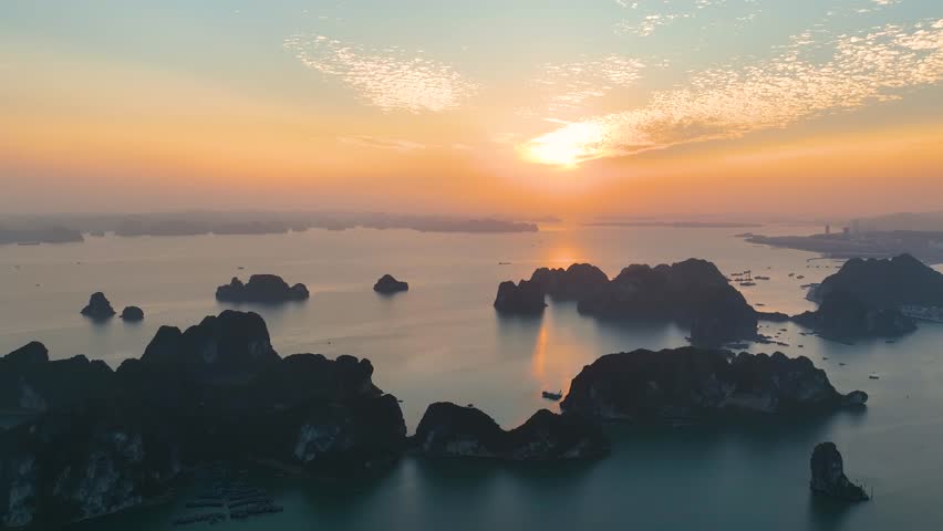 Aerial view floating fishing village and rock island, Halong Bay, Vietnam, Southeast Asia. UNESCO World Heritage Site. Junk boat cruise to Ha Long Bay. Popular landmark, famous destination of Vietnam