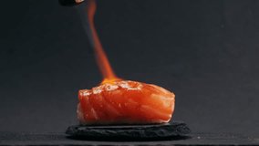 Chef cooking Sashimi Nigiri Platter with flambe fire, japanese sushi restaurant, Fresh Tuna and Salmon Slices in modern cafe, traditional food, raw red fish dish, omega 3. - Powered by Shutterstock - Get 15% off with code: PIKWIZARD15