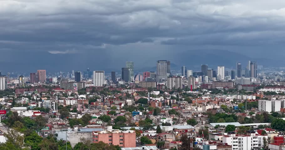 Hyperlapse of the skyline of Paseo de la Reforma in Mexico City on a cloudy Saturday afternoon, watching the storm approach and some planes beginning to descend at the airport