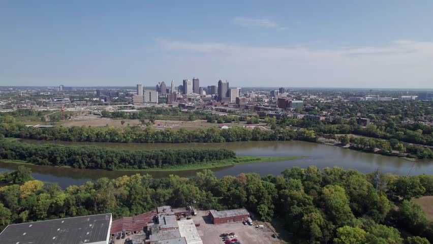Population and capital city center of Columbus, OH, with aerial view of Scioto river, buildings, skyscrapers, business, traffic, metro parks, and Ohio people on a sunny summer day